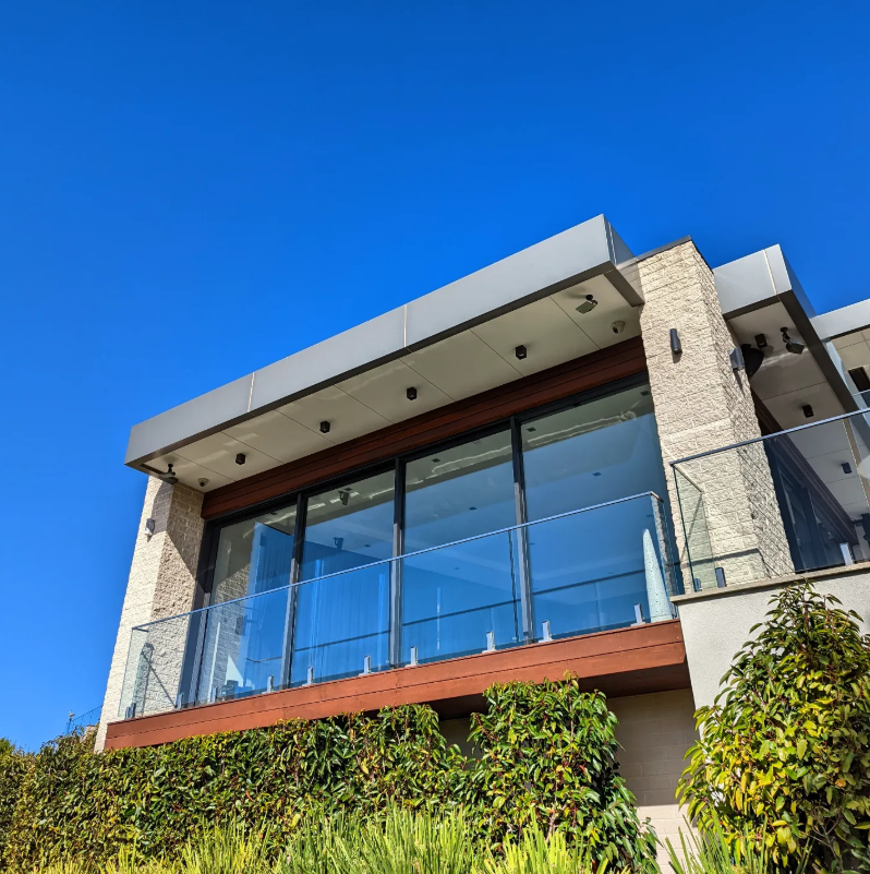 Modern home with clean glass balustrade and windows